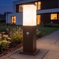 Brilagi - Lampada da esterno con sensore di movimento NOVA, 1x E27/15W/230V, 40 cm, IP44, marrone